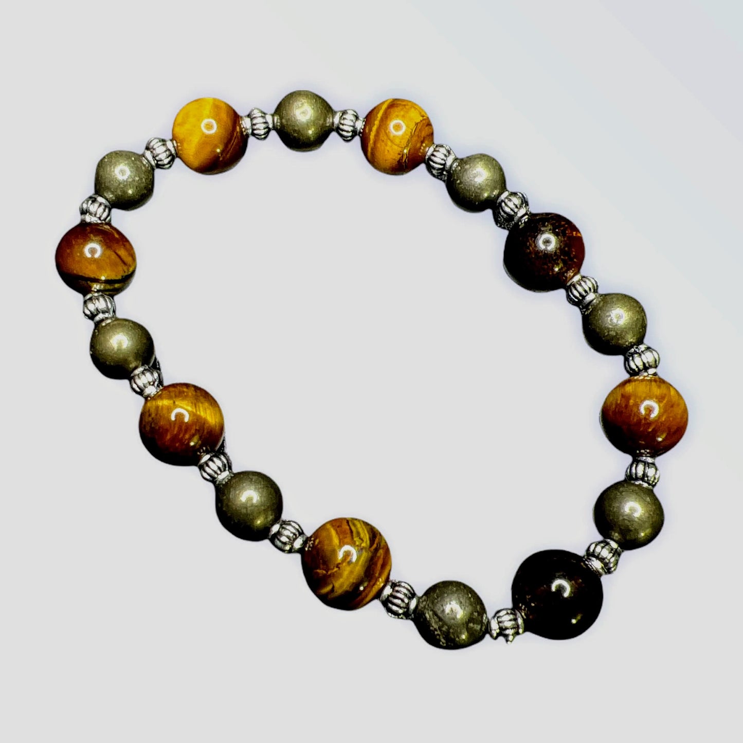 Tiger Eye-promotes vitality and physical action / Pyrite-works on the physical, etheric, and emotional levels to shield and protect from all types of bad vibrations and/or energy. It has the potential to improve both physical and mental well-being.