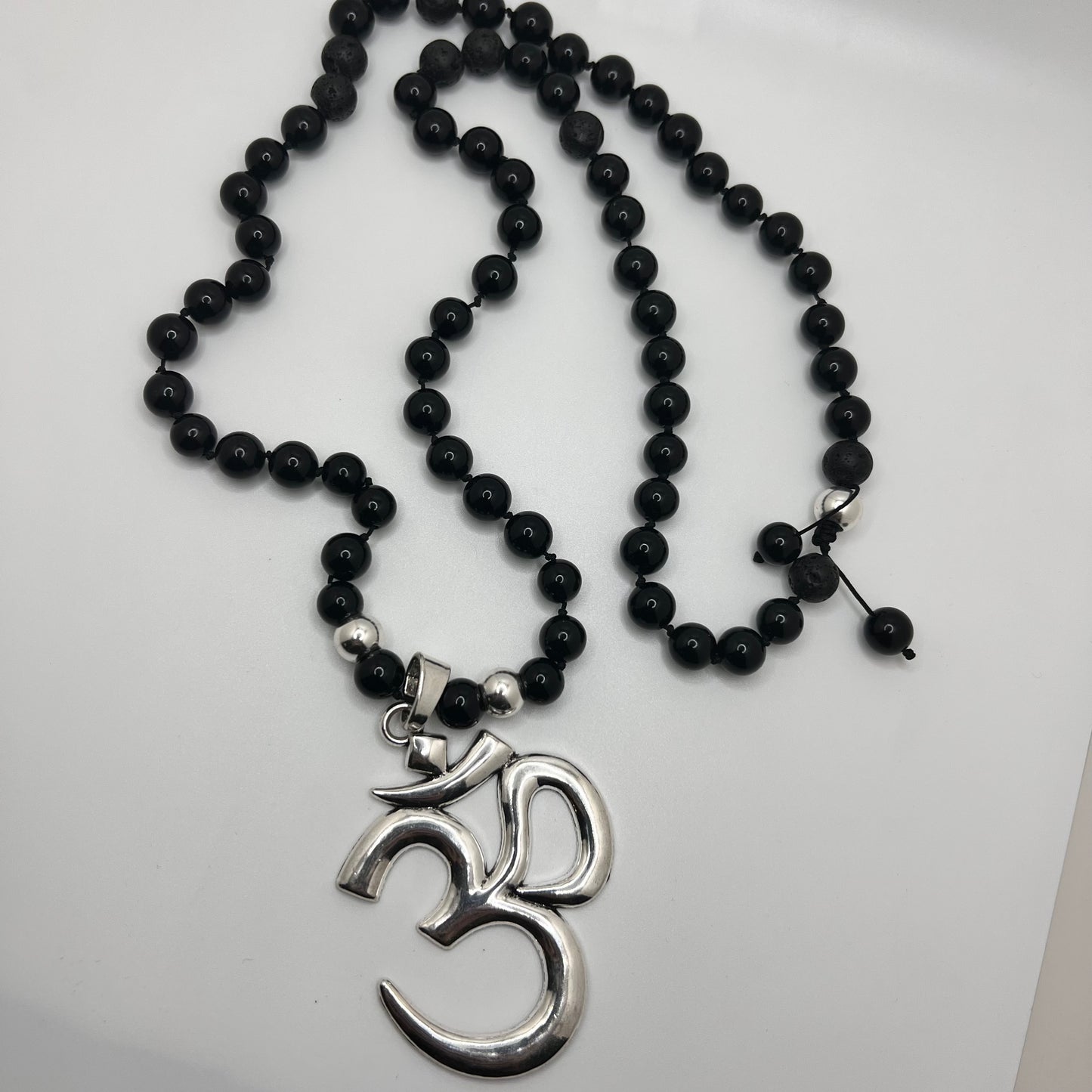 OM Pendant (.925 sterling silver pendant)with Onyx: increase regeneration, happiness, intuition, instincts /Lava:grounding and calming. stabilizes the root chakra— Necklace (lenth 32”)